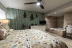  bedroom suite, king size bed, jacuzzi hot tub, towel rack, lamps, ceiling fan, dresser